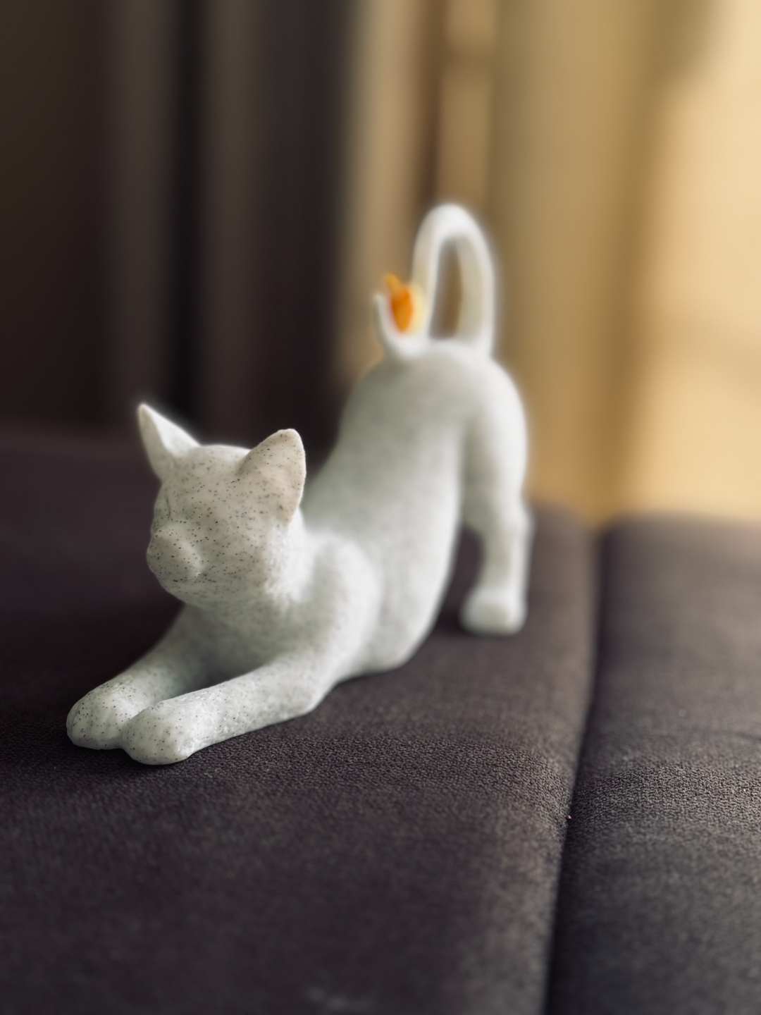 Stretching Cat with Bird on Tail