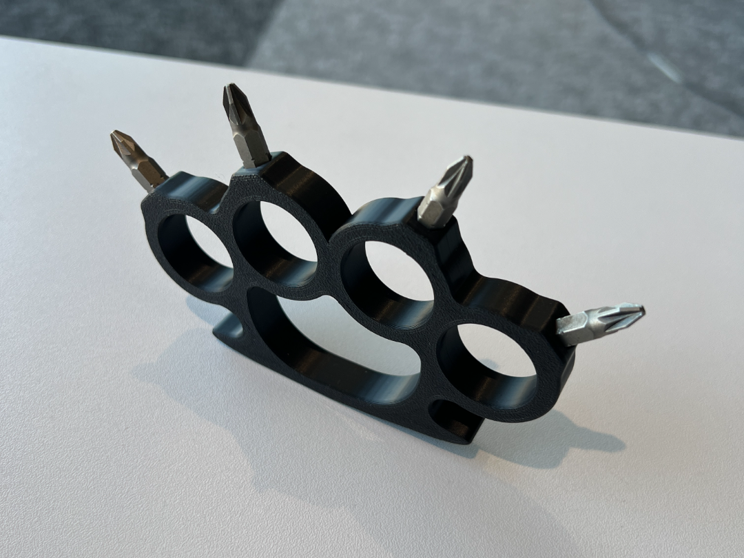 Brass knuckles with screwdriver attachments