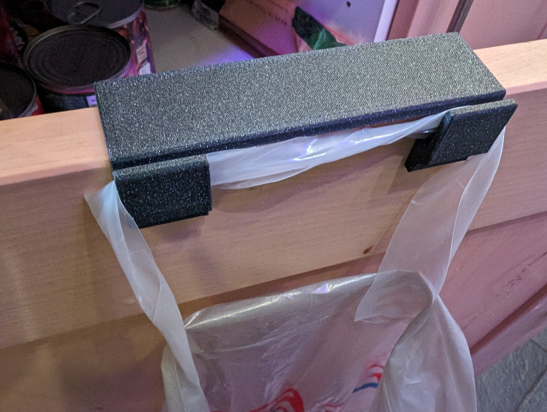 Plastic bag holder for cupboard door