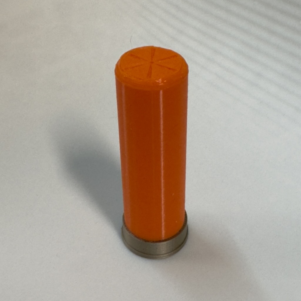 Container shaped like 12 gauge shell