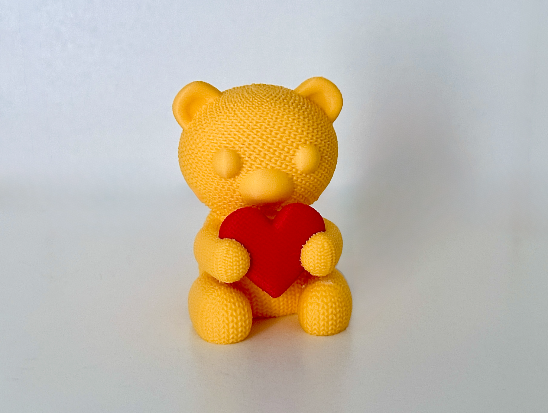 Knitted bear with heart
