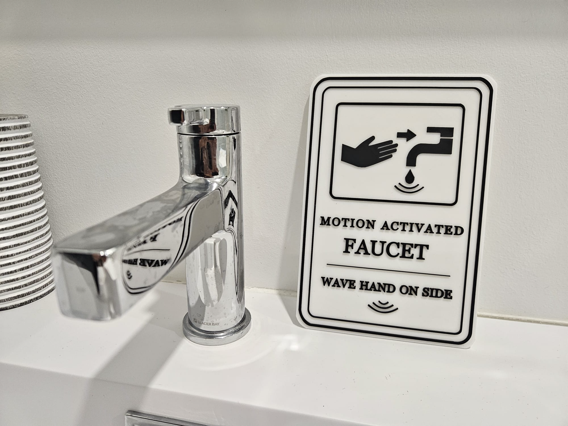 Motion activated faucet sign
