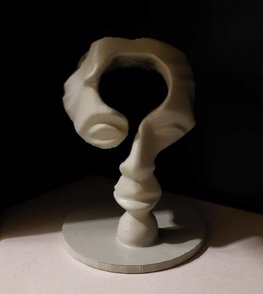 Question mark sculpture with facial features