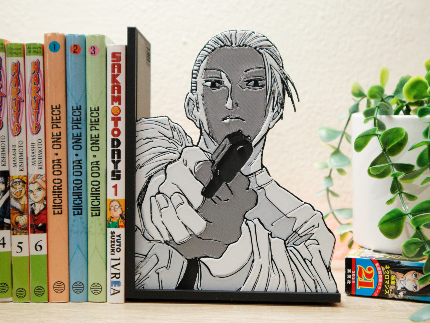 Bookend of young Taro Sakamoto aiming