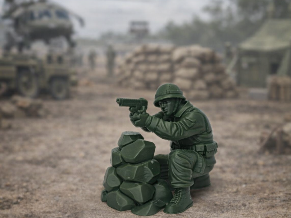 Green Army Toy Soldier Crouching Rock Wall War