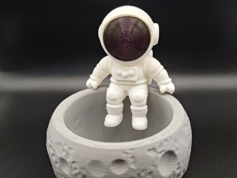 Moon bowl with sitting astronaut