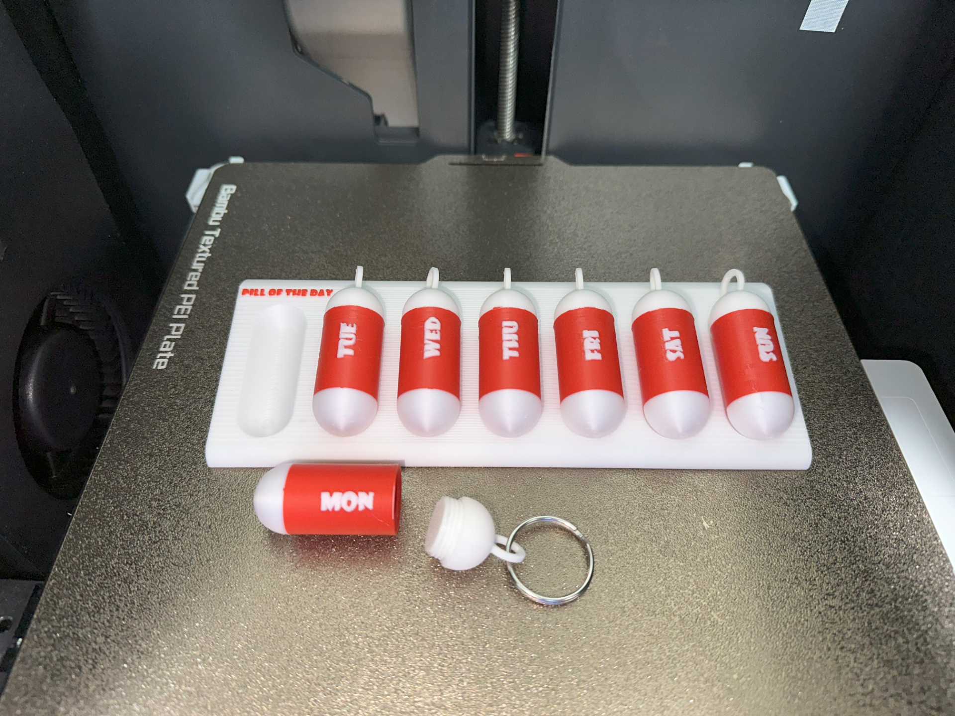 Pill organizer with detachable container
