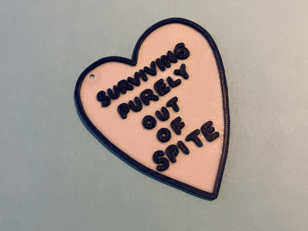 Surviving purely out of spite heart keychain