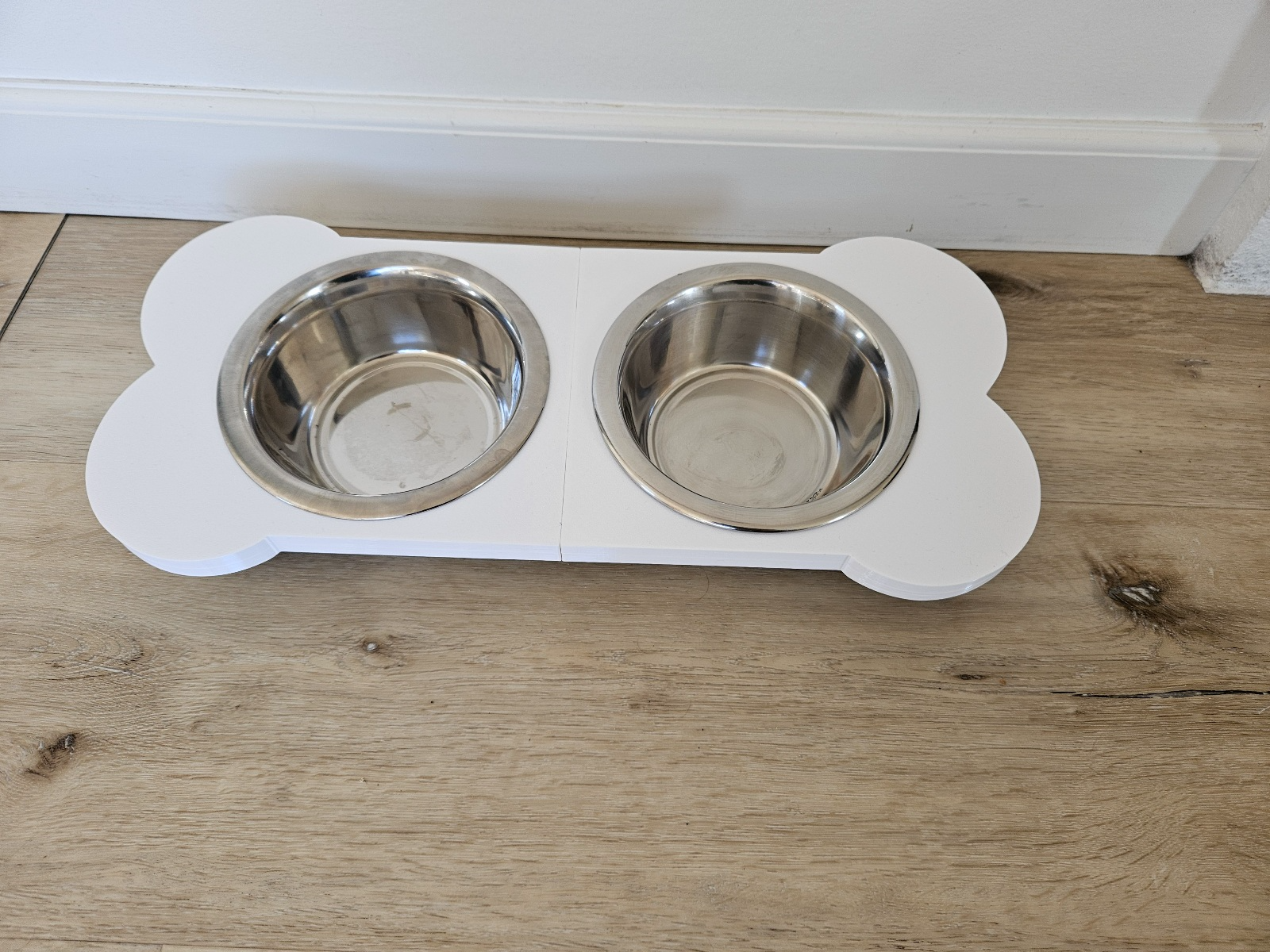 Bone shaped dog food bowl riser