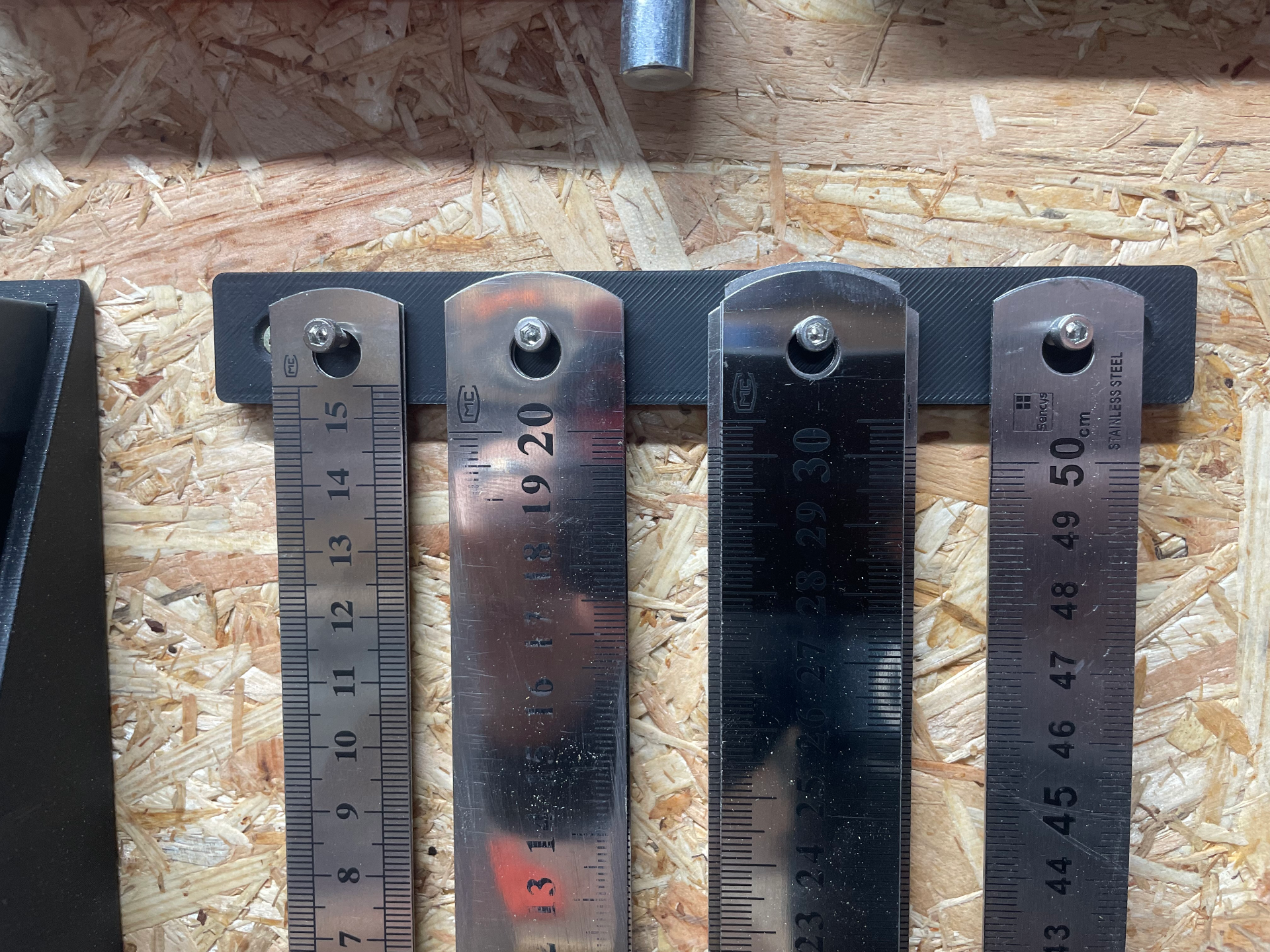 Simple wall-mounted ruler holder