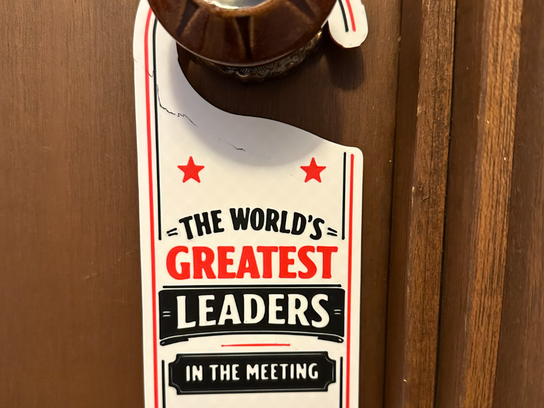 World's greatest leader in the meeting door sign