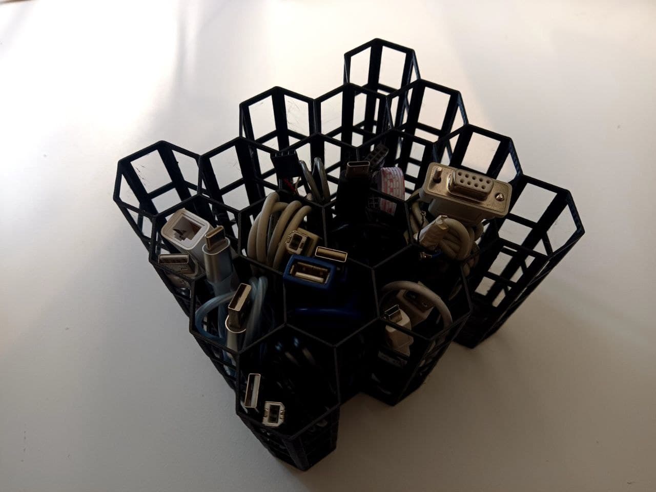 OpenSCAD Fully parametric drawer cable storage management hive with punch cuts