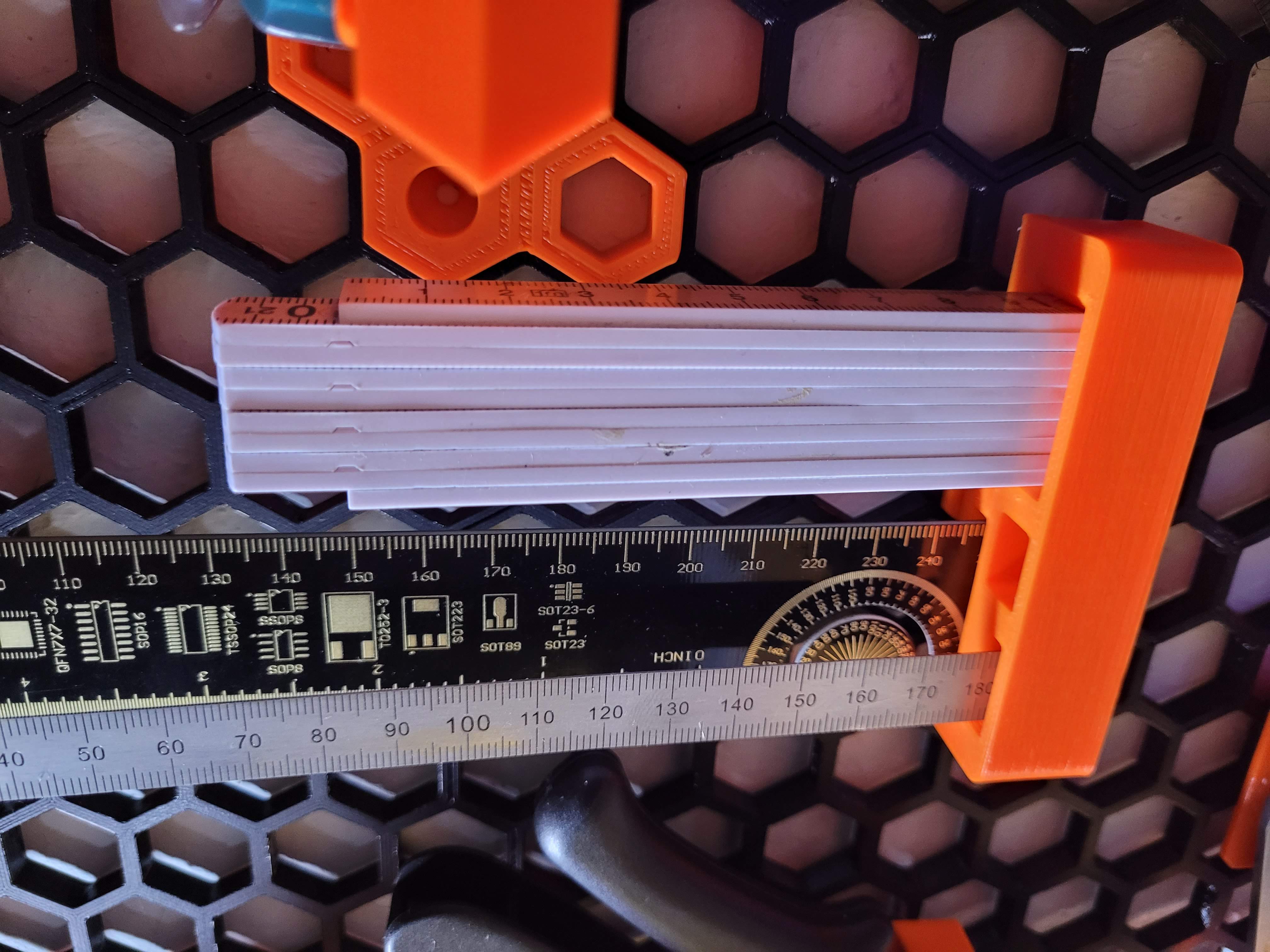 Ruler and folding tape measure holder for HoneyCombWall